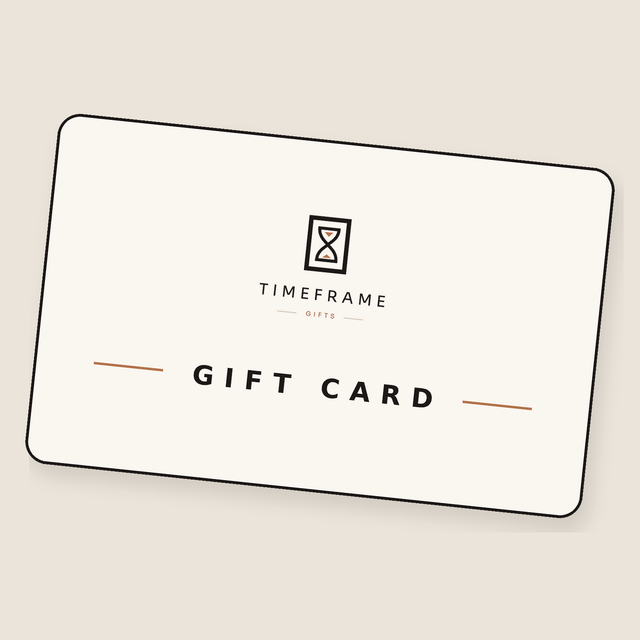 TimeFrame gift card with hourglass logo, angled on a warm cream background